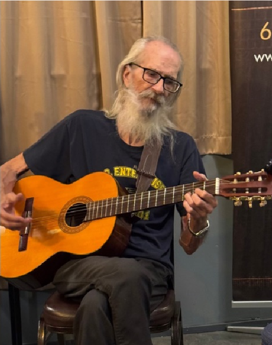 Photo of Don Cook playing his guitar